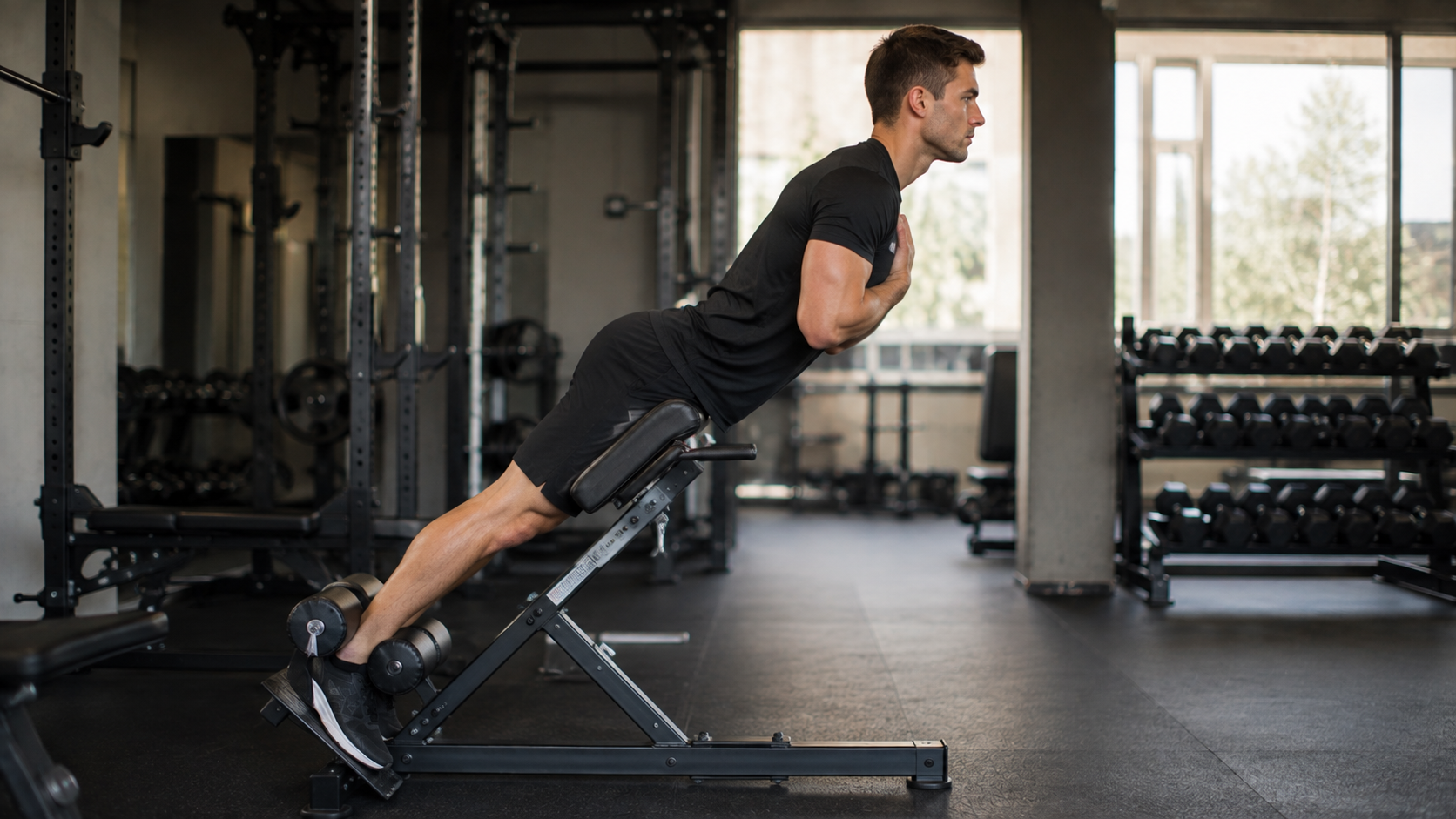 A person doing a back extension on a roman chair in a gym